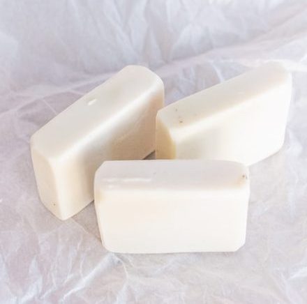 white soap bar on white textile